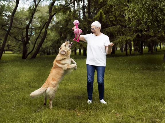 Paciente passeando e bricando com o cachorro no parque 